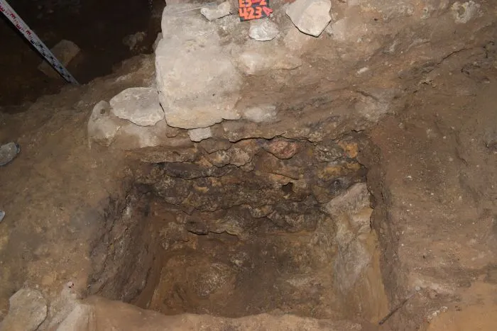 A fragment of the stone pillar inside the cave. Photo by M. Urbanowski