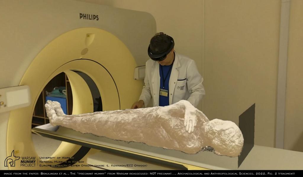 A hologram of the mummy created using the mixed reality (XR) technique from computed tomography images. It was obtained using the Polish CarnaLife Holo software (MedApp) for HoloLens systems (Microsoft) and virtually placed on the tomograph table where the mummy was originally examined.  Ł. Kownacki (ECZ Otwock)