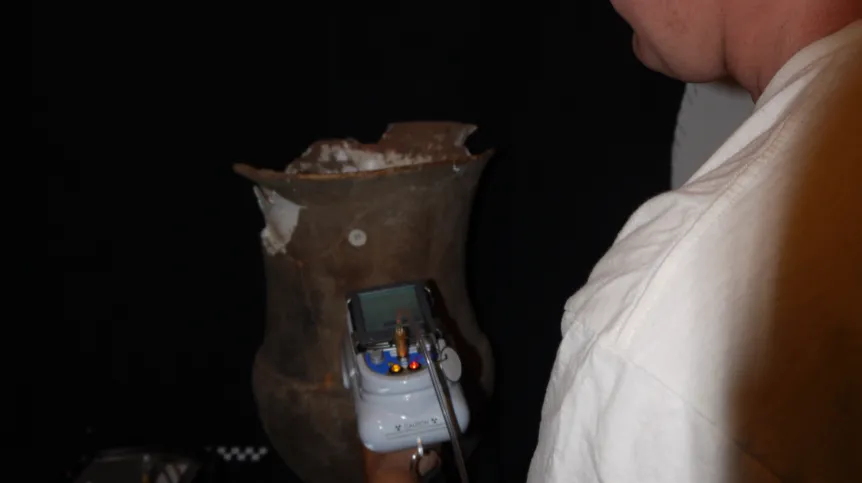 Dr. Michał Krueger performs an analysis of a vessel using manual XRF spectrometer. Photo by A. Gomez