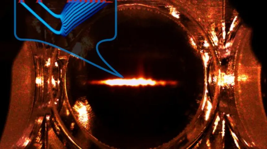 Photograph of a cloud of Rubidium-87 atoms, the most important part of quantum memory used to demonstrate the time telescope with record resolution. The insert shows an example of experiment result with two short pulses at the telescope's input (left), the Fourier transform of which is the comb visible at the output (right). (Source: Faculty of Physics, University of Warsaw, photo by M. Mazelanik)