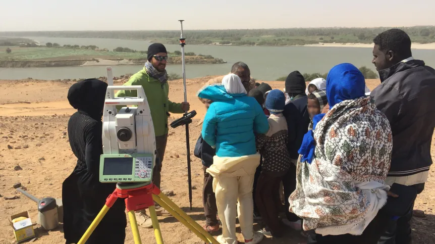 Adrian Chlebowski explains his survey work to local school students. Credit: T. Fushiya