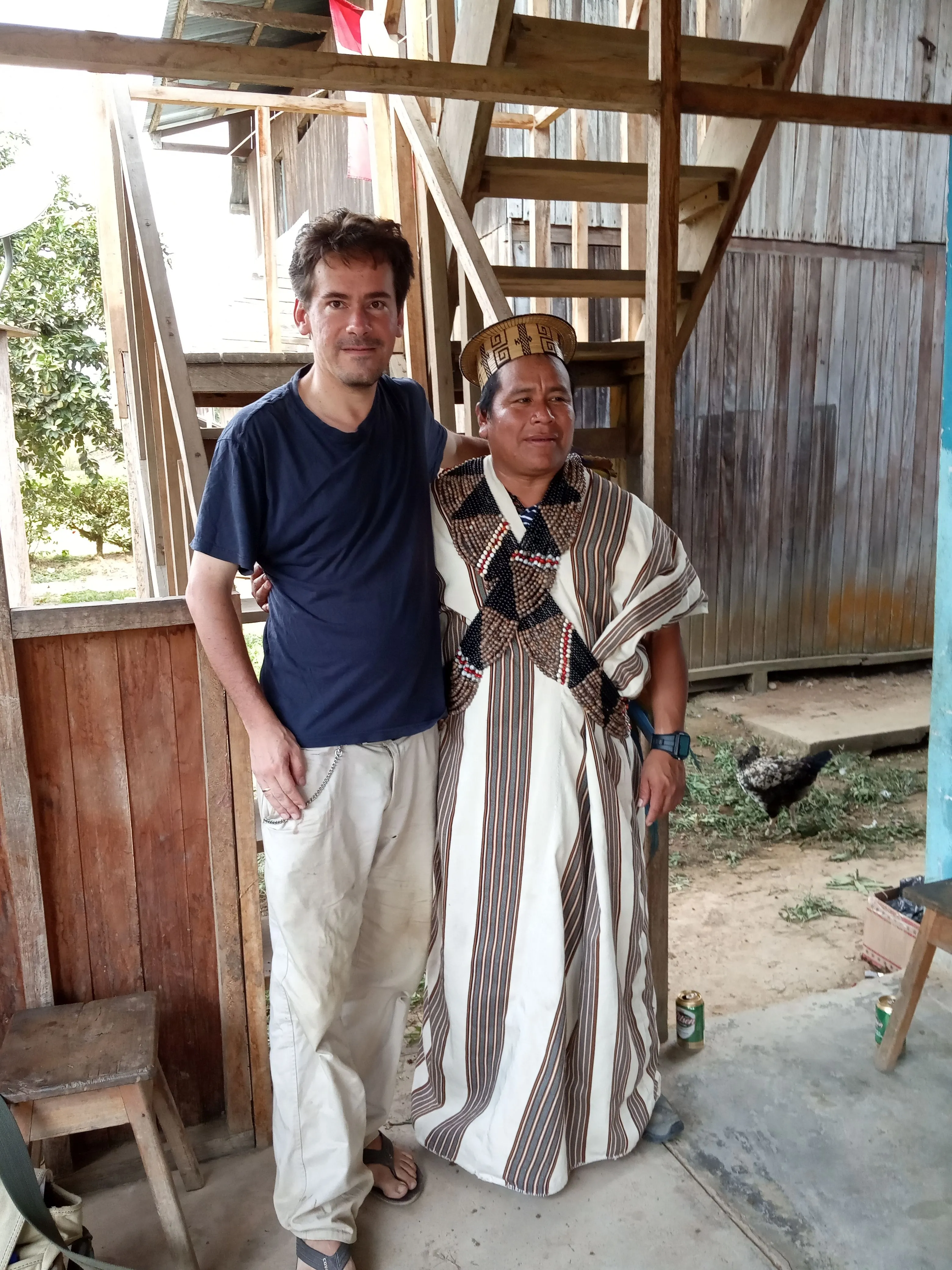 Anthropologist Kacper Świerk in the company of Daniel Ríos Sebastian - the mayor of the Megantoni district. Daniél, a Machiguenga from Nuevo Mundo, wears a tunic, a matsairintsi head gear and bandoliers from seeds (including Job's-tears (Coix lacryma-jobi) and ormosia seads). Nueva Luz, photo by Carlitos